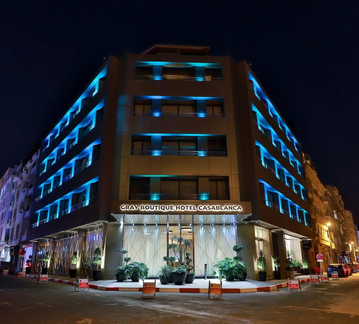 Façade of the Gray Boutique Hotel Casablanca lit in blue at night, with its sign