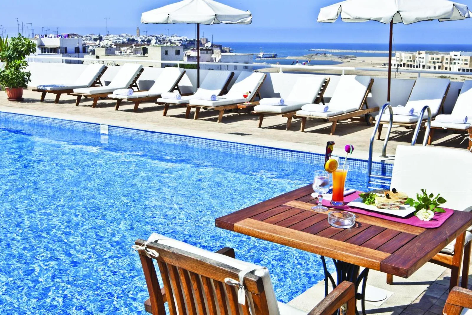 Rooftop pool at the Hôtel Borj Rabat with its sun loungers and a view over the city and the coast