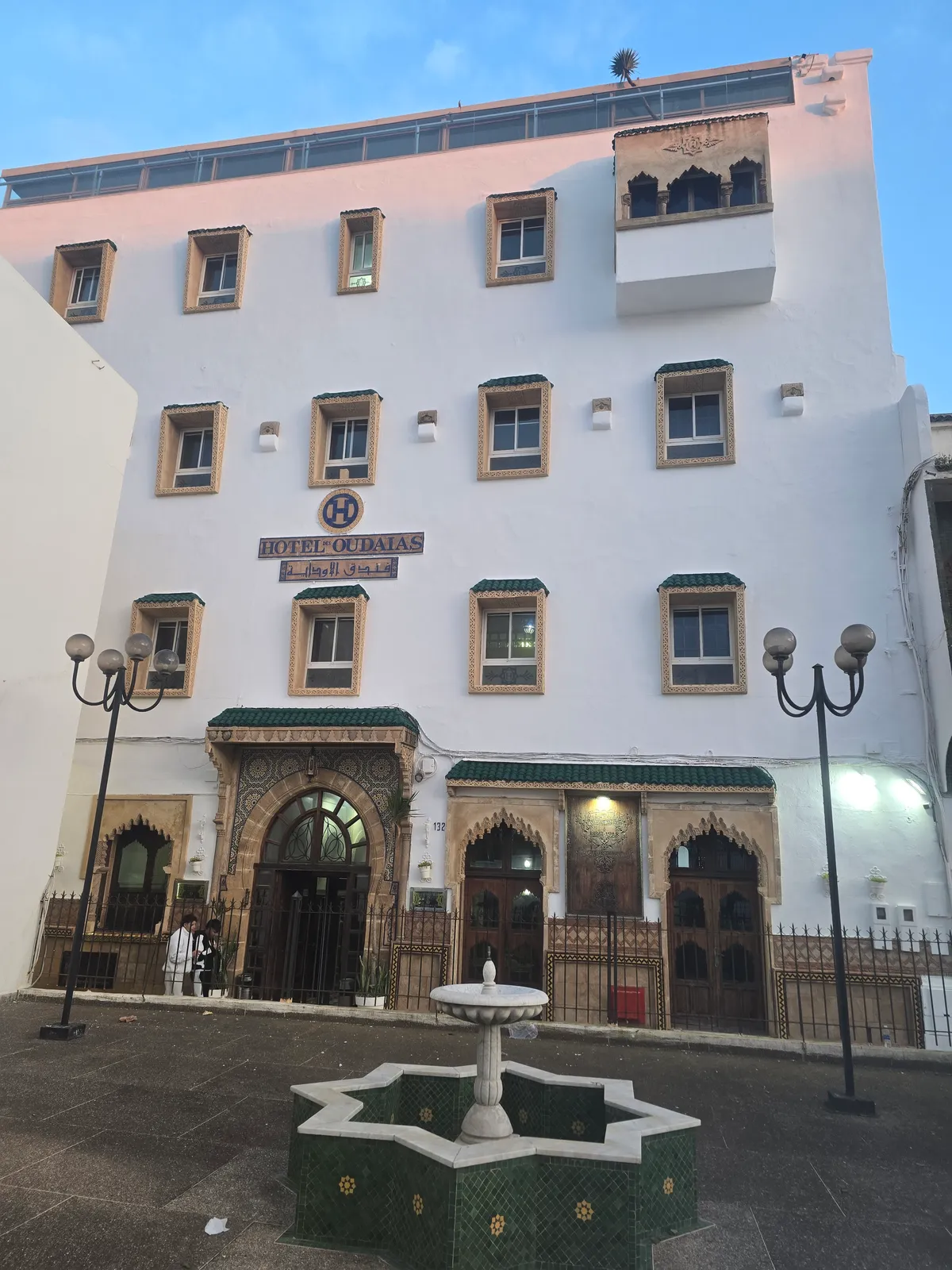 Façade of the Hôtel des Oudaias in Rabat, with its decorated doorway and the fountain in front