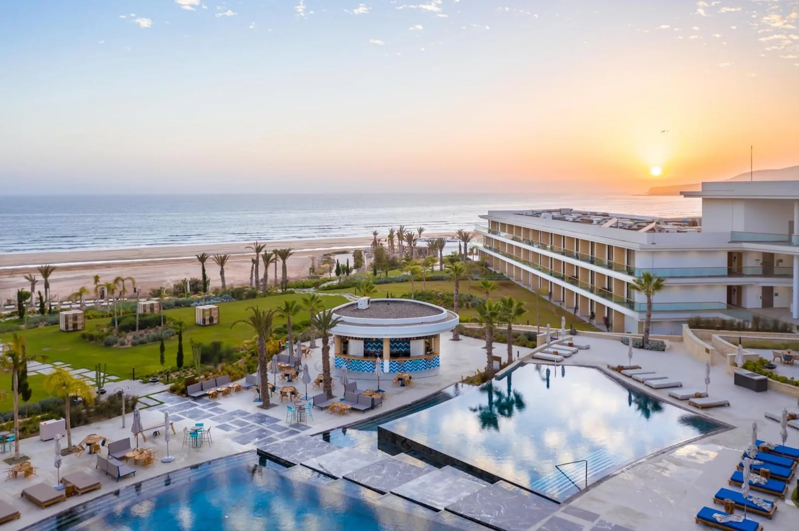 Aerial view of the Hyatt Regency Taghazout at sunset, between the beach, the gardens and the pool