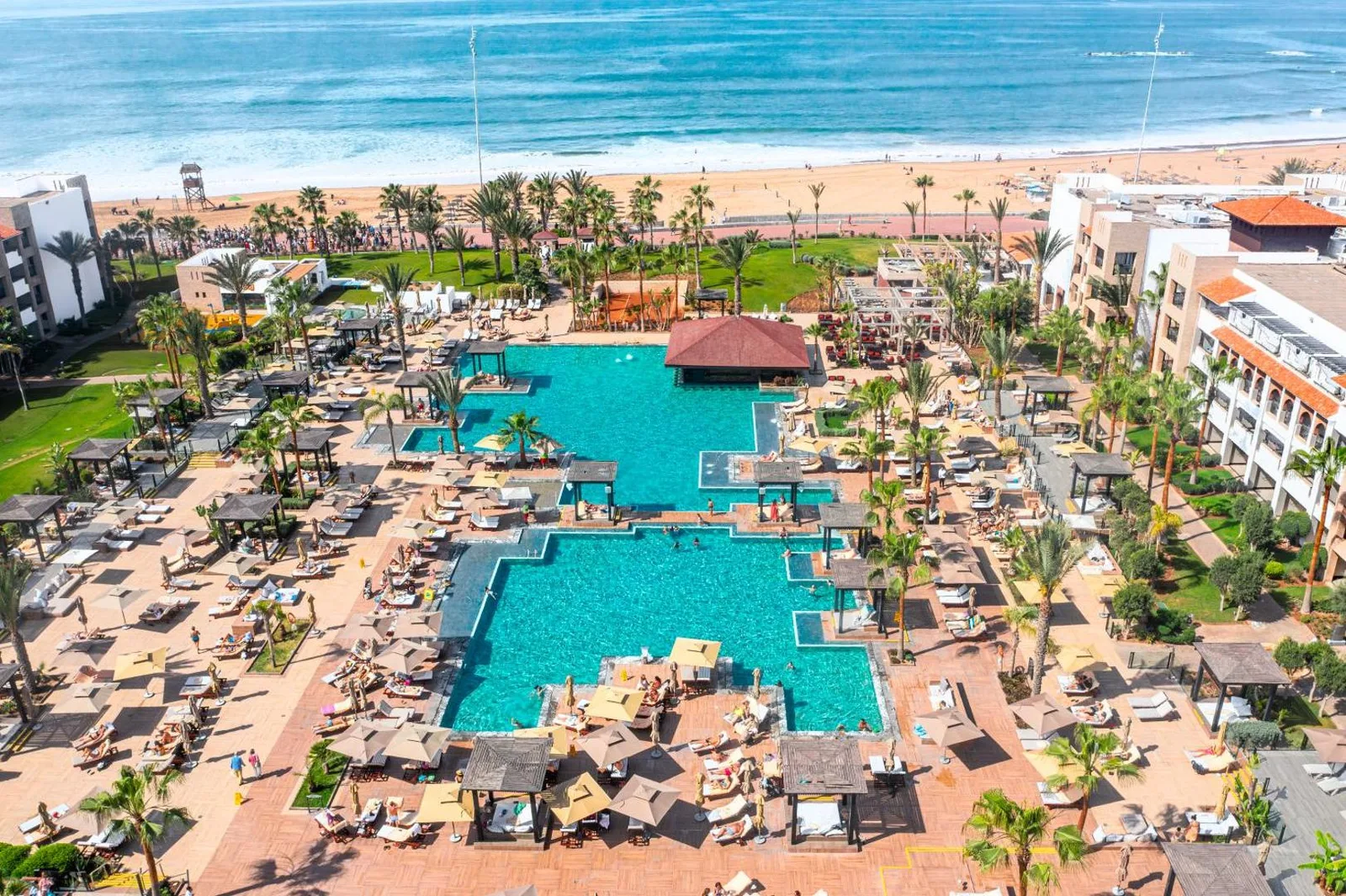 Aerial view of the Riu Palace Tikida hotel's pools with Agadir beach in the background