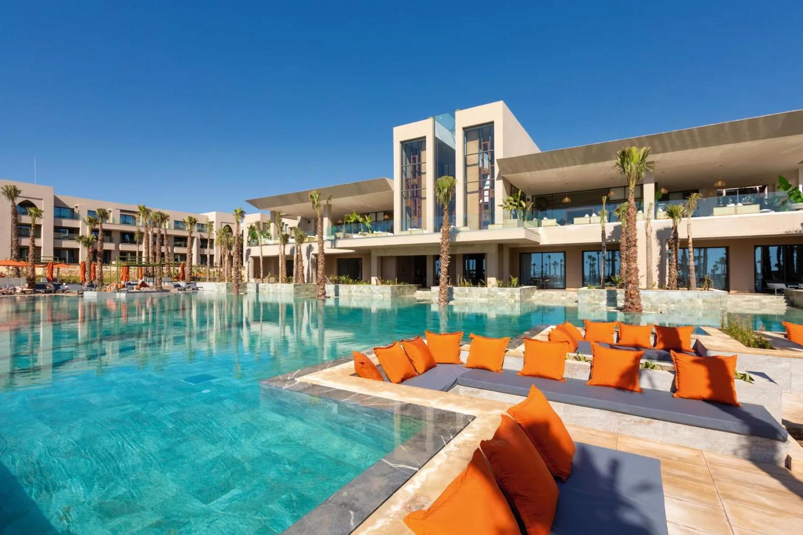 Main building of the Riu Palace Tikida Taghazout, opening onto a large palm-lined pool