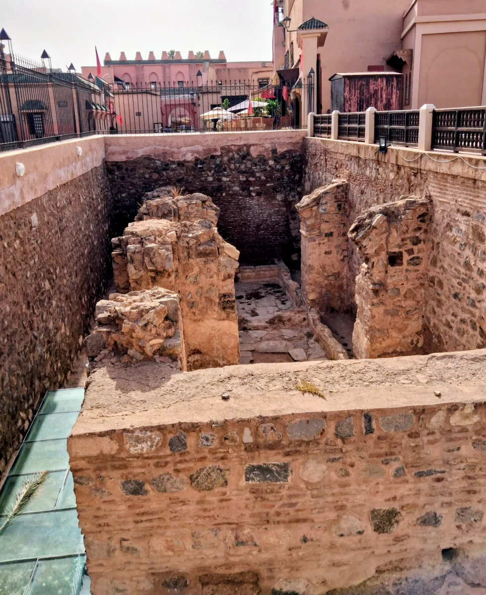 Vue en plongée axée sur le fossé archéologique et le fondement du bassin/salle des ablutions
