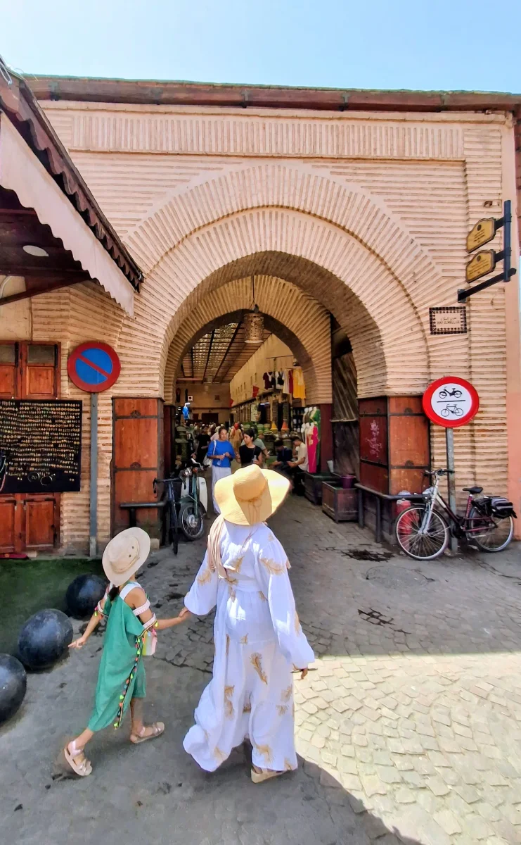 Family with children at the entrance to the souks of Marrakech in the Medina