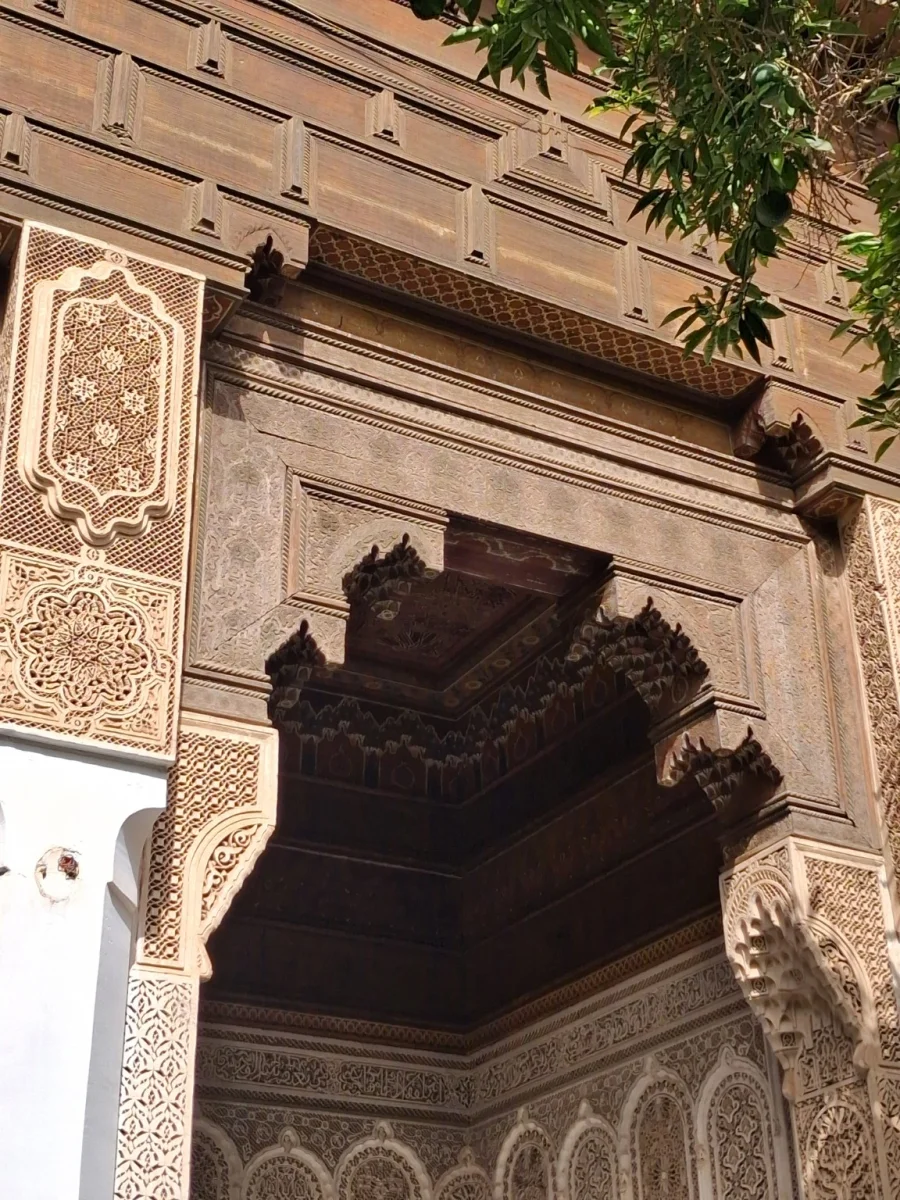 Detail of a carved wooden cornice or frieze, known locally as a Gayza, at the Bahia Palace in Marrakech.