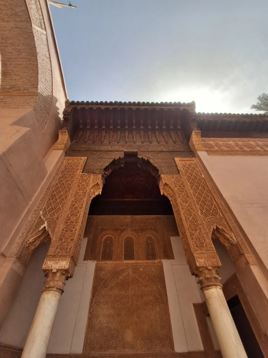 View of the ornate architecture of the Saadian Tombs in Marrakech, highlighting carved stucco details and intricate woodwork characteristic of Saadian art.